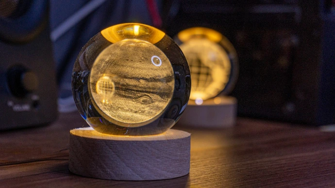 Illuminated planet globes sit on wooden bases